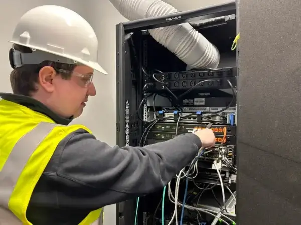 technician inspecting rack for emergency power services