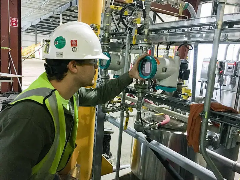 metal processing system inspection by a technician