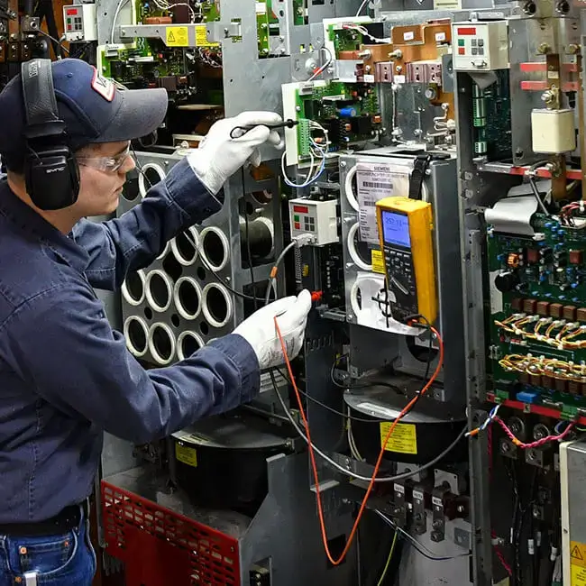 technician testing the new line electrical control panel