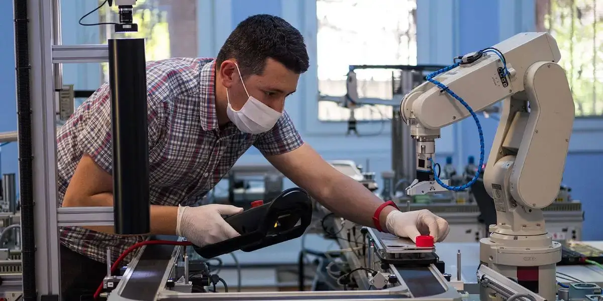 technician testing robot compliance with ansi ria r15.06:2012