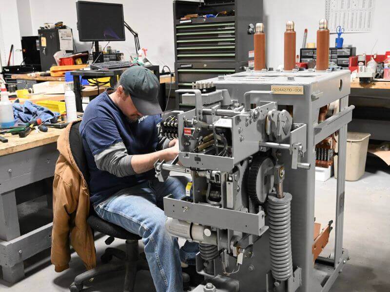technician repairing equipment showing signs of a bad circuit breaker
